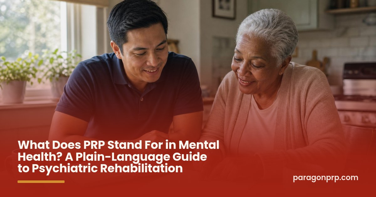 A caregiver and an older woman review a weekly plan together at her sunlit kitchen table, smiling and relaxed.